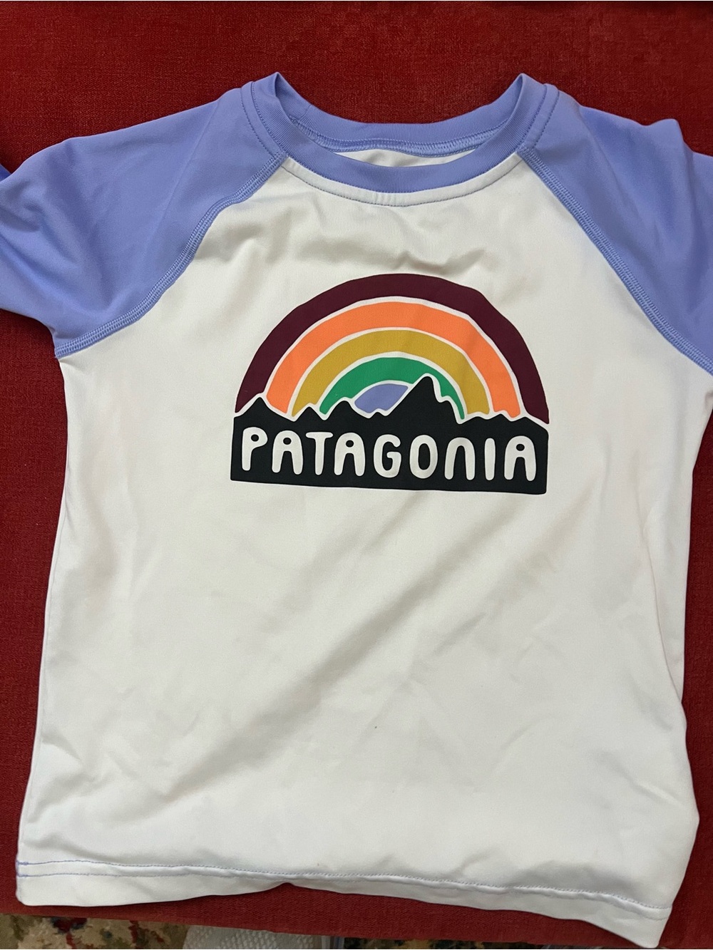 Patagonia Kids White Rash Guard with Lavender Sleeves and Rainbow Logo